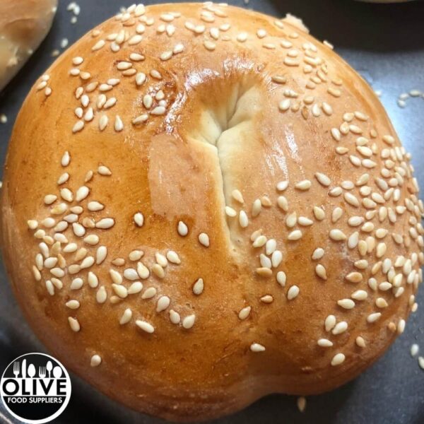 a close up of a baked sesame bagel
